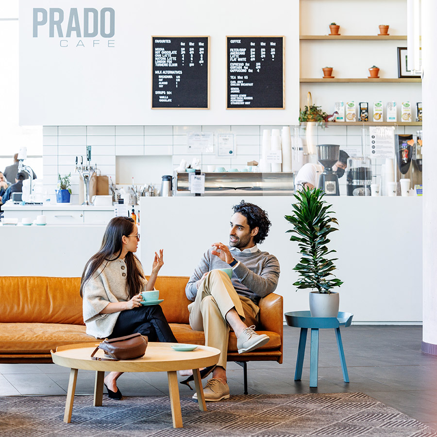 Man and woman talking while sitting at a coffee shop