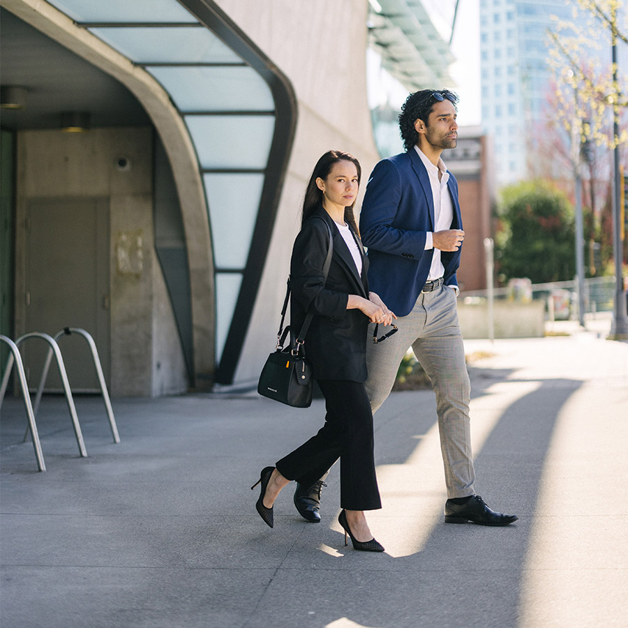 Man and woman walking in front of a building